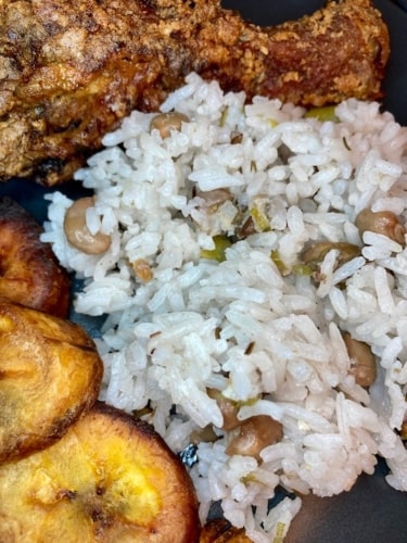 Jamaican rice and pigeon peas meal with Jamaican fried chicken and fried sweet plantains.