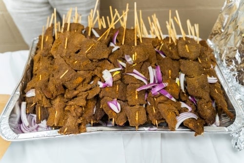 Beef Suya in a tray on a table representing Nigerian Party Food Ideas.