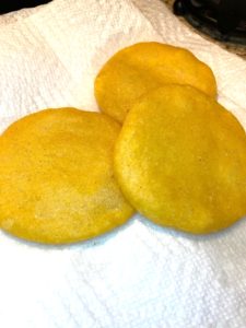 Thick corn tortillas from Panama displayed on paper towels used to drain excess oil.