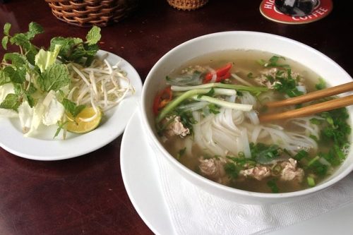 Picture of bowl of pho with toppings